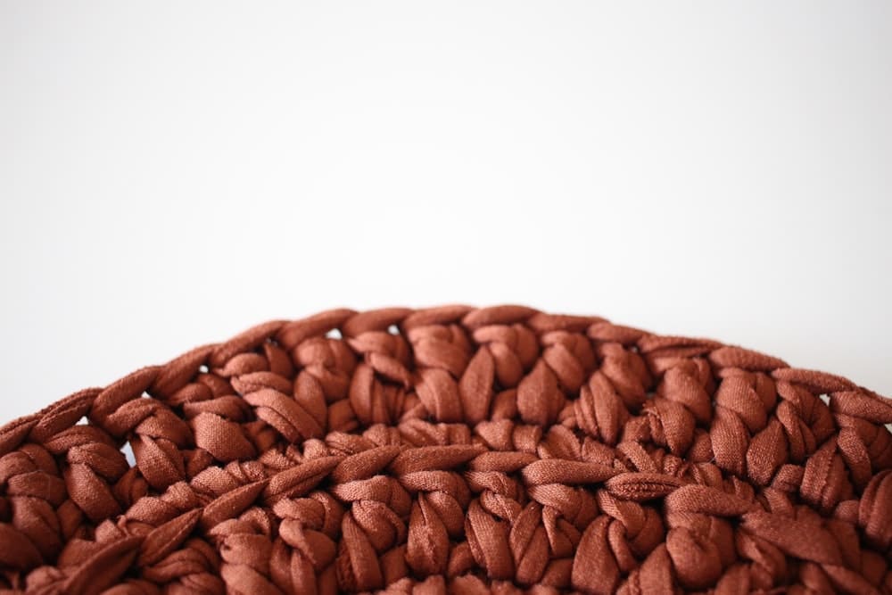 Close-up of a rust-colored crocheted basket texture